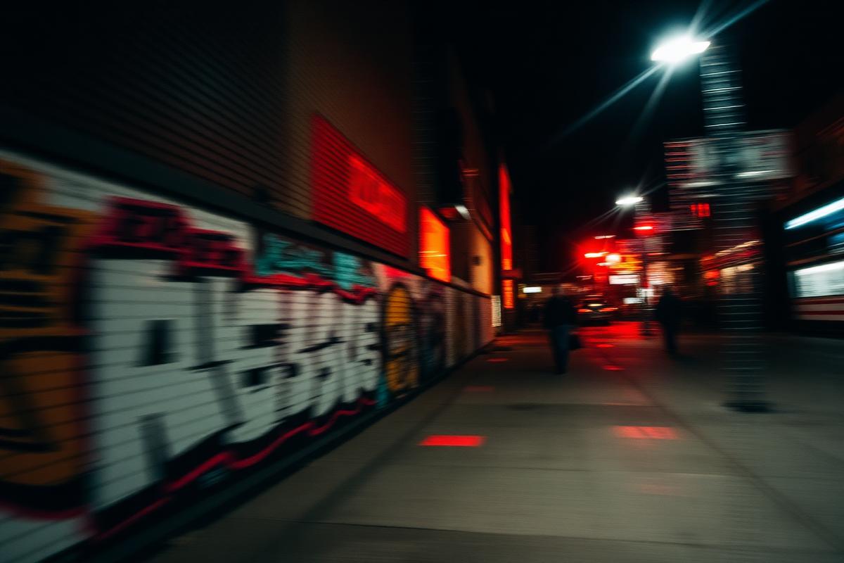 Night street culture, graffiti wall and neon city lights